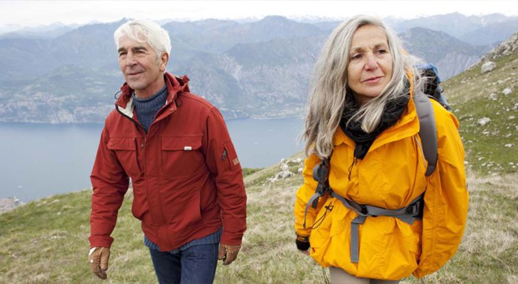 Elder couple walking on the mountains 